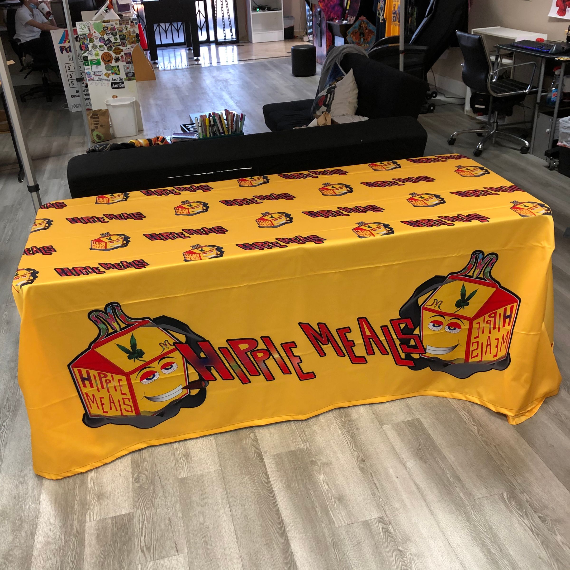 Full-color Hippie Meals branded 6ft table throw on a folding table