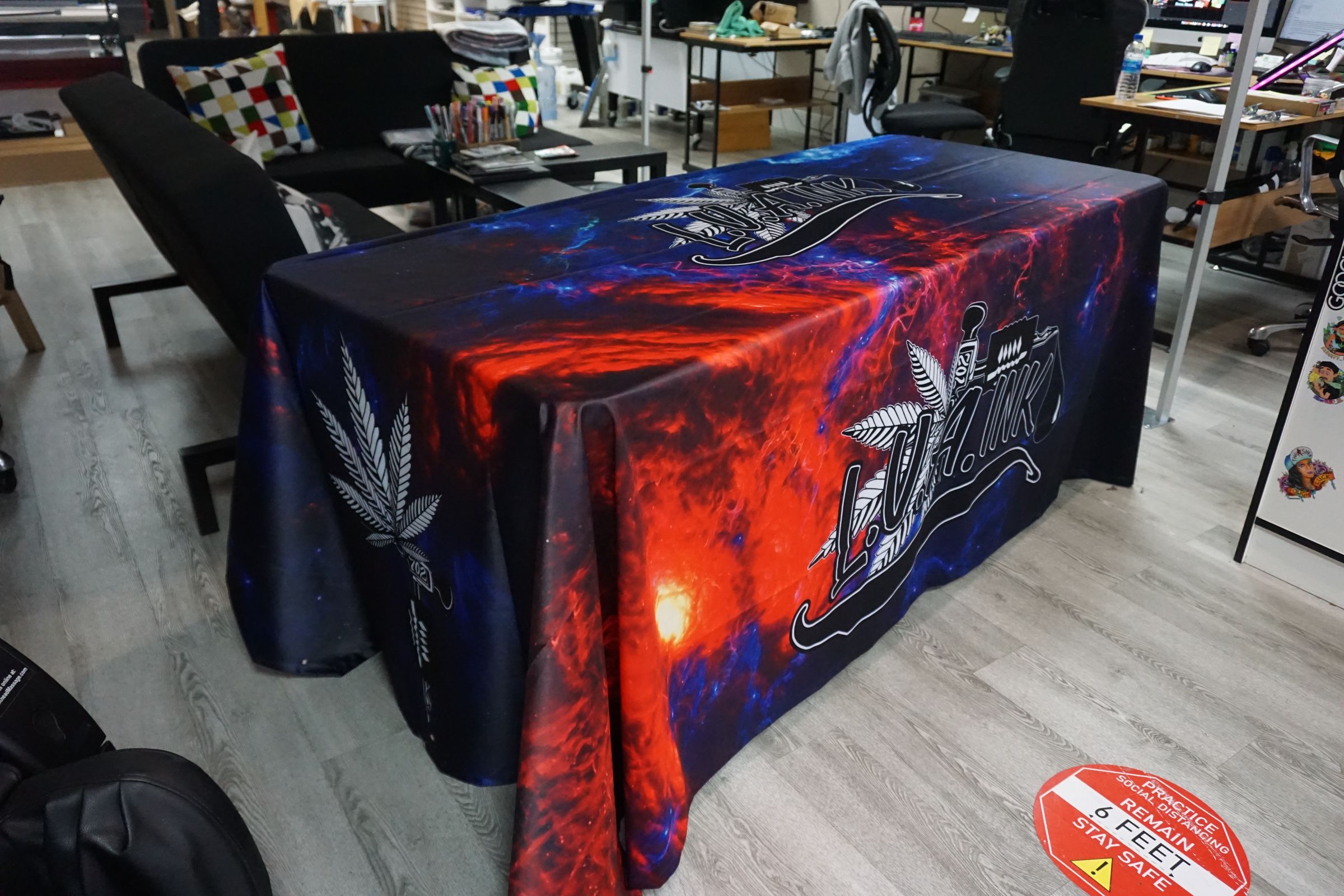 Red and blue galaxy-print 6ft table throw with LVA Ink logo