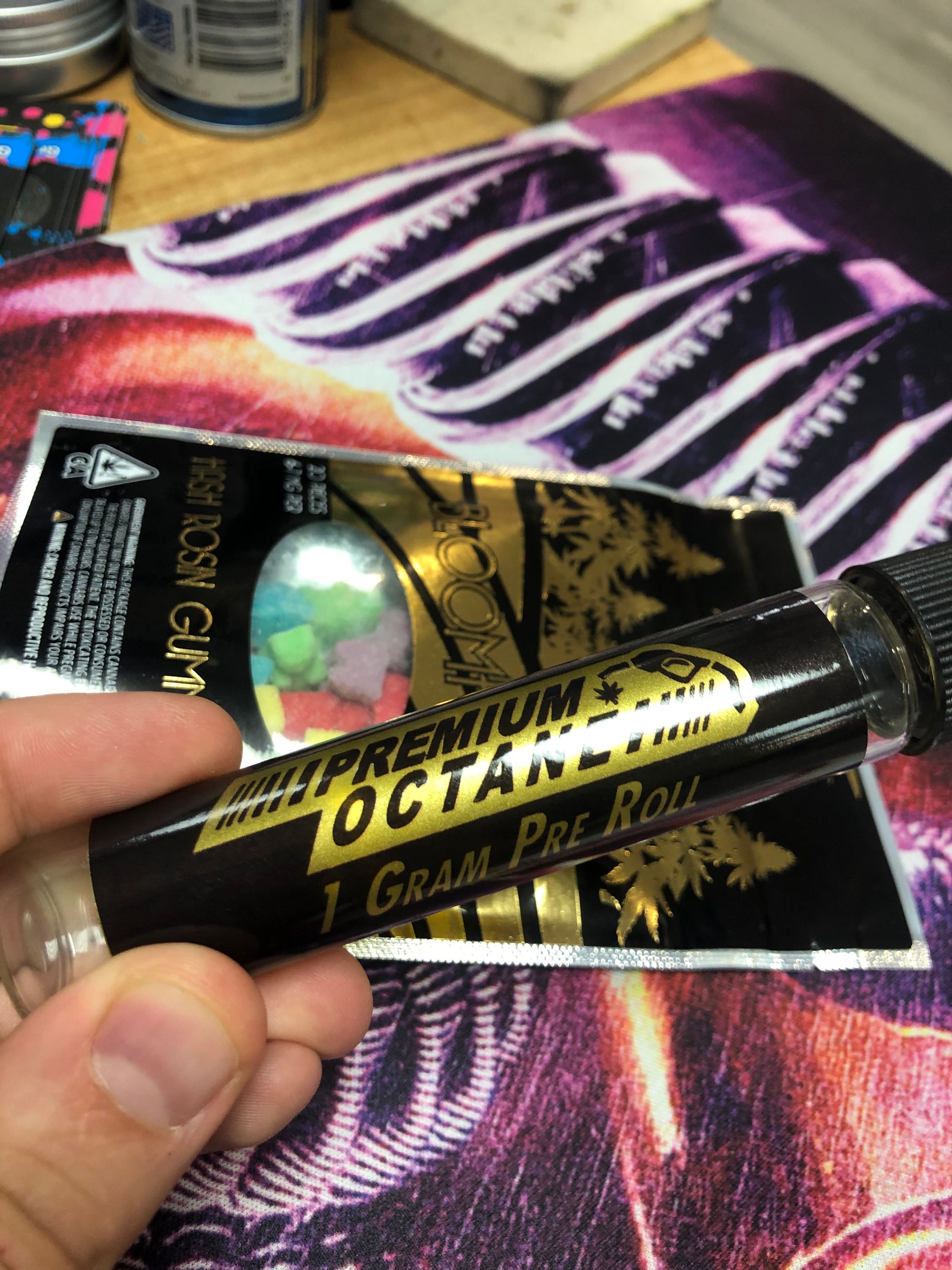 Close-up of metallic gold print on a black pre-roll tube label