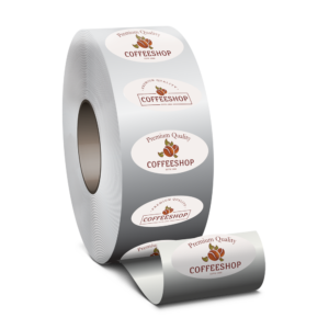 Graphics Design Media prints custom roll labels and stickers, shown here as oval Coffeeshop branding labels unwinding from a large roll.