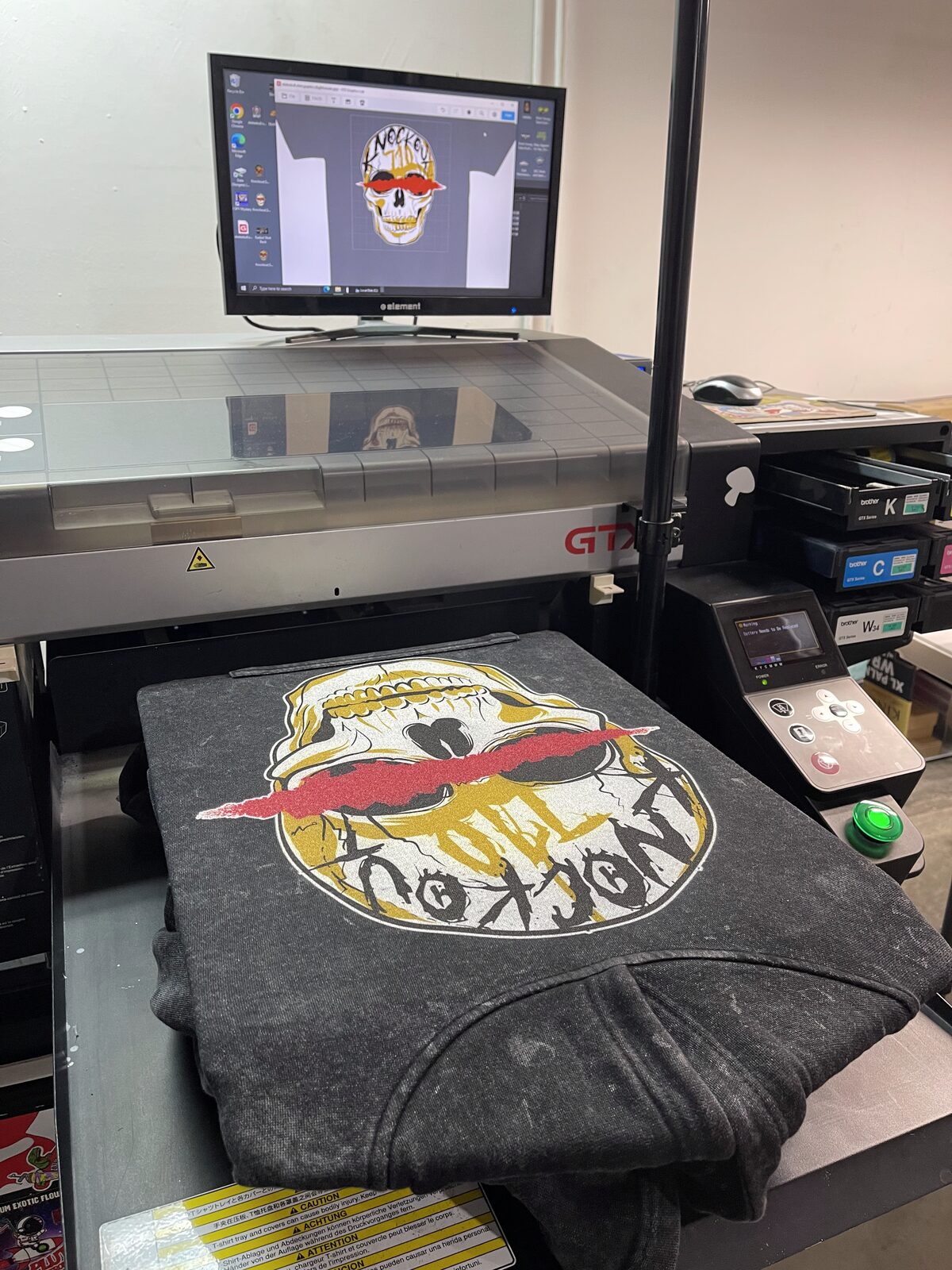Our Brother GTX Series DTG printer in the Graphics Design Media shop with a design loaded and ready to print