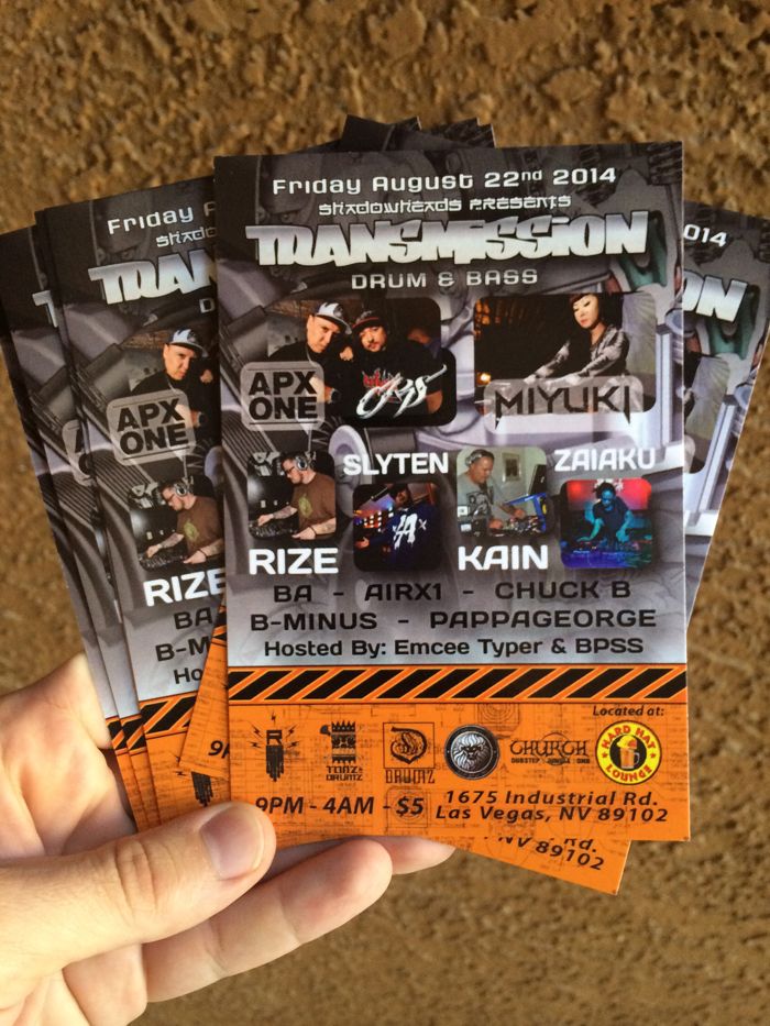 Hand holding printed orange event flyers
