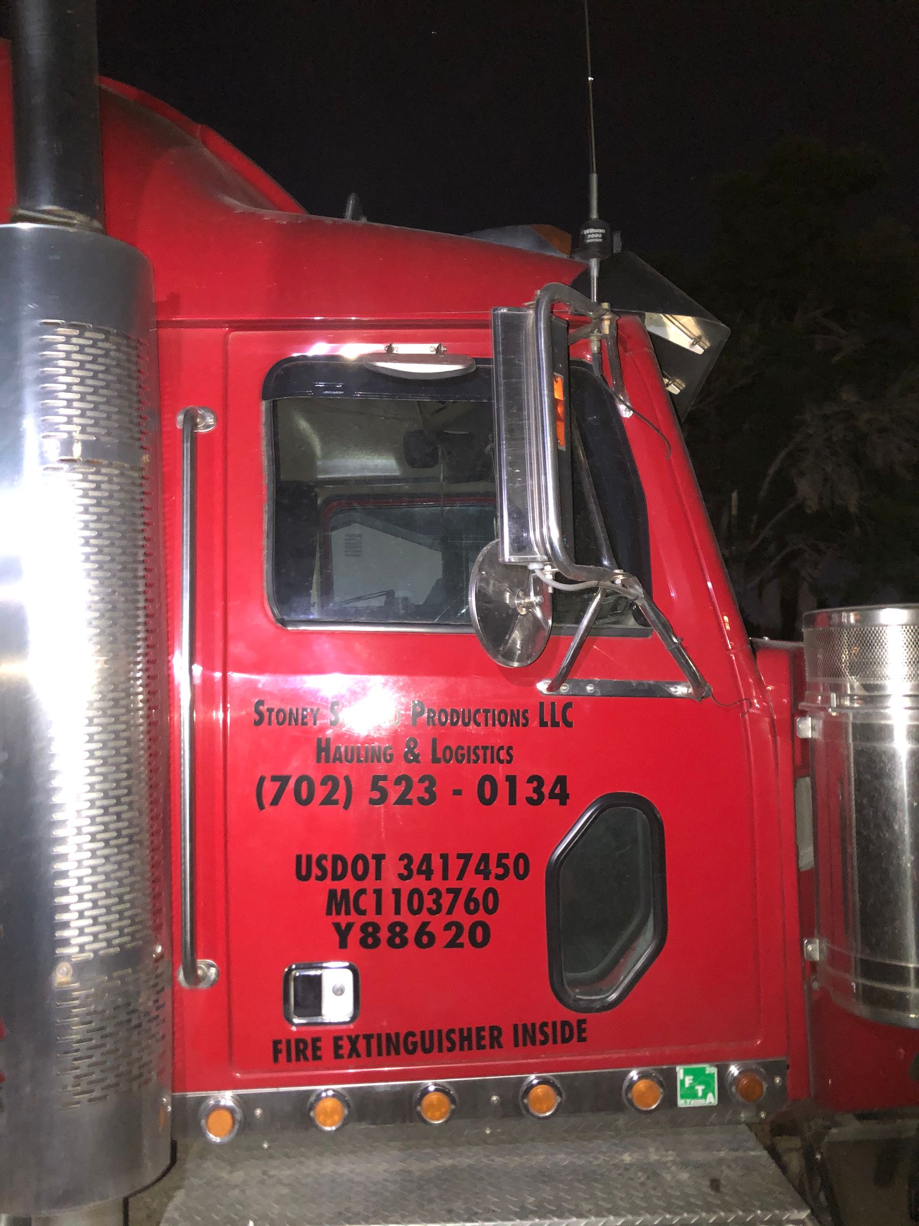 Red semi truck door with black vinyl USDOT and company lettering