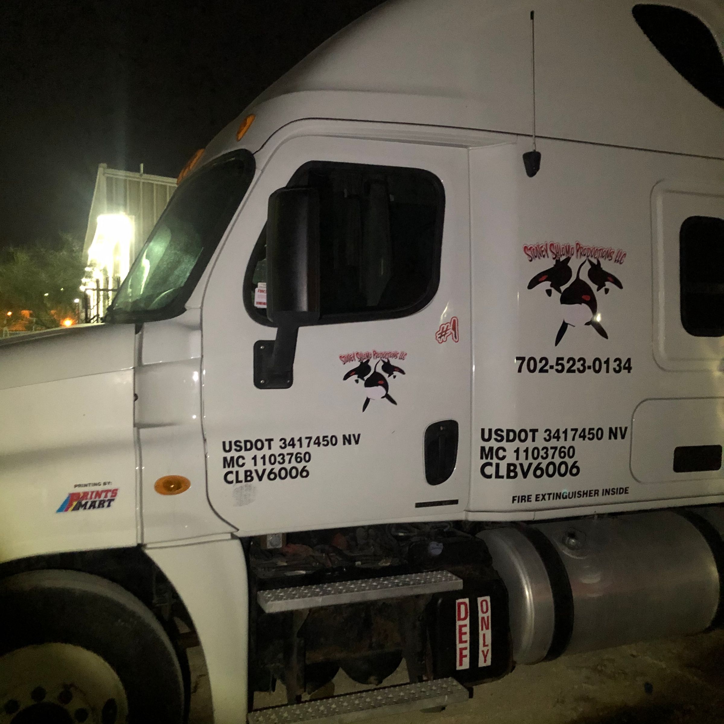 White semi truck cab with custom logo and USDOT number lettering