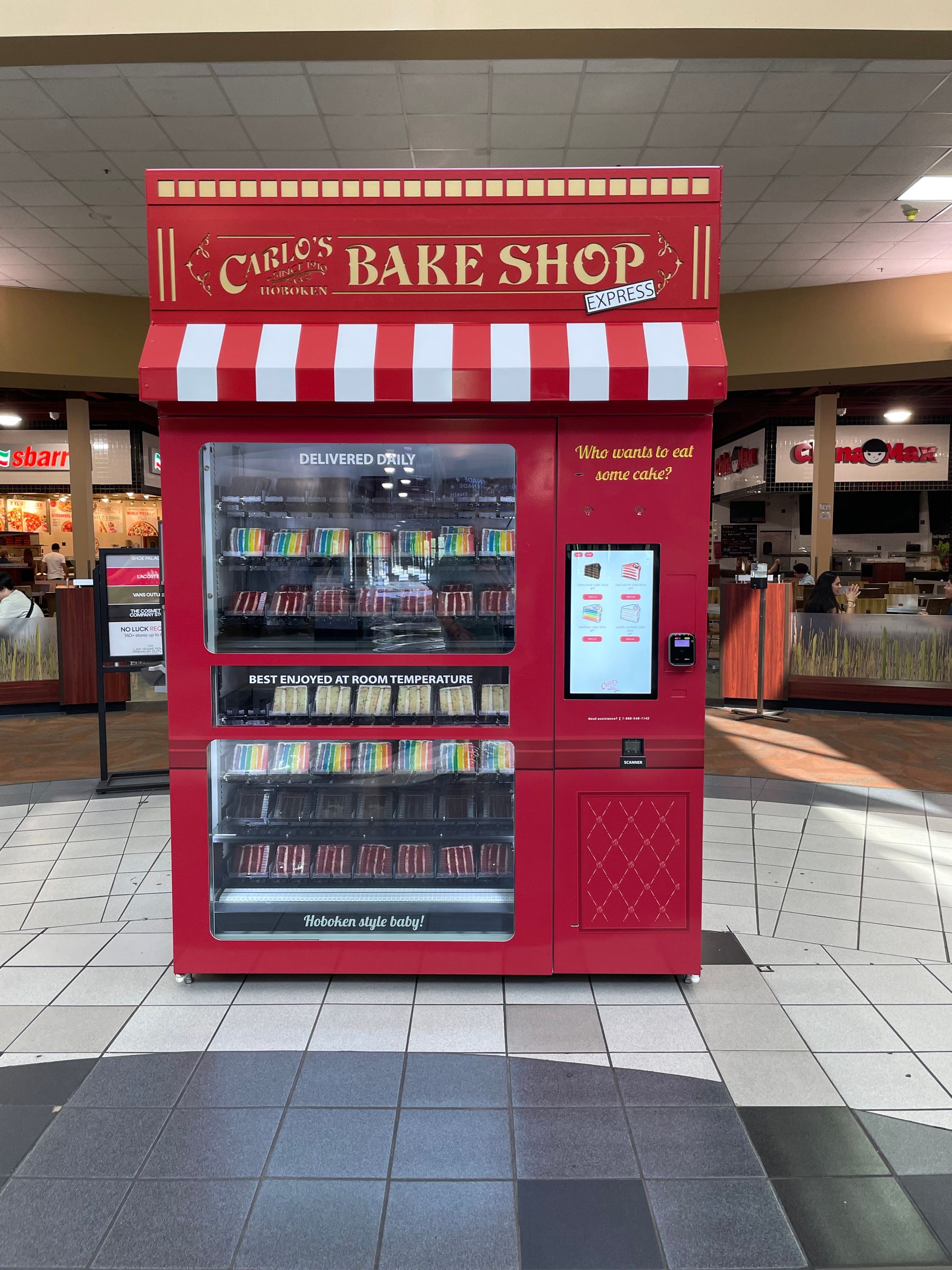 Red bake shop themed vending machine wrap in a mall